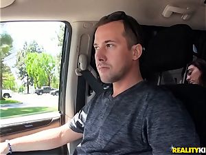 Monique Alexander blows a gigantic beef whistle in the car